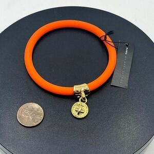 Marc by Marc Jacobs Orange
Silicone Stretch Bracelet with Gold
Charm NWT